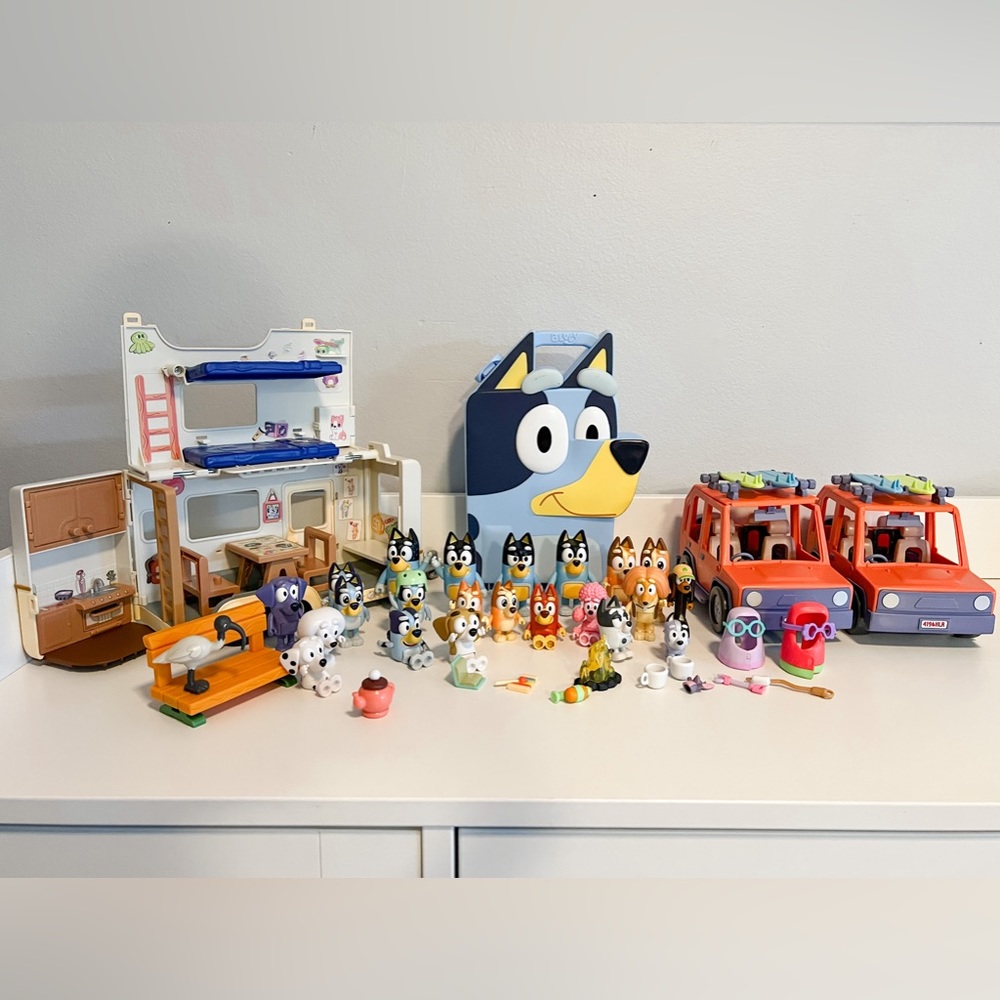 Multiple sets of Bluey figurines, 2 cars, camper, and accessories.